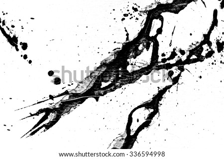 Ink splatter, black acrylic paint splash isolated on background texture grunge. Blood splash, spray. Abstract acrylic hand painted splash. Black and white color. Close up.