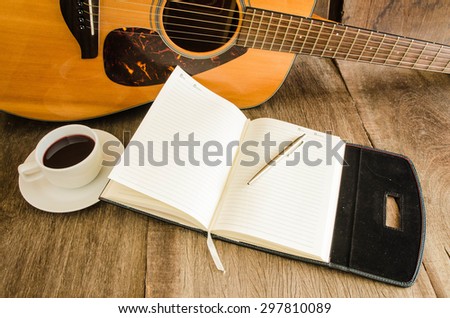 Coffee and acoustic guitar on board