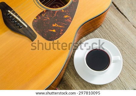 Coffee and acoustic guitar on board