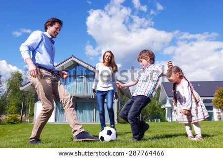 family playing football in front of their house