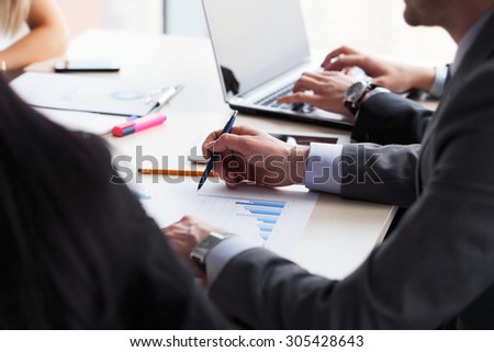 Business people working together with financial reports