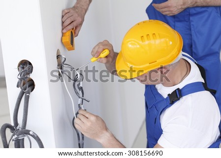 electrician making wiring at new house