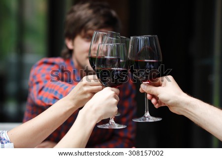 friends toasting with wine at dinner