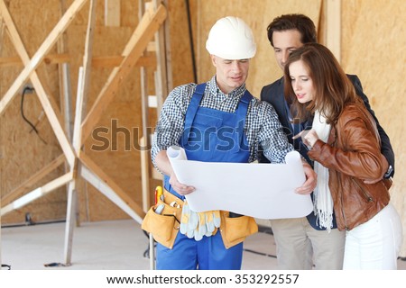Foreman shows house design plans to a young couple