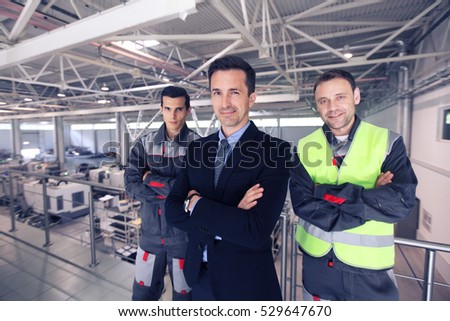 Team of manager and two workers in CNC factory
