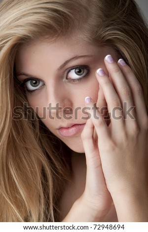 Intense close-up of pretty teenage girl with big eyes and beautiful hair and nails