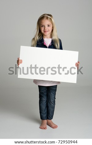 Cute little girl isolated on neutral background holding sign