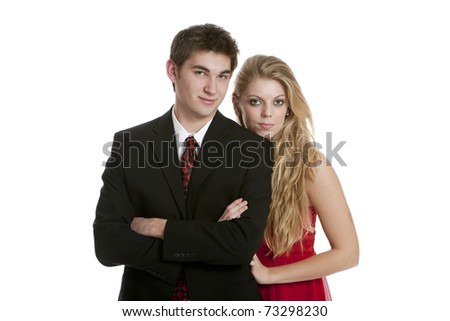 Teenage couple dressed in formal clothing standing close together isolated on white background