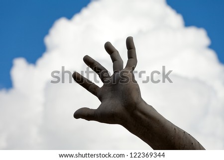 the stony hand against the background of the sky. Roma - Piazza Navona square, Italy. Detail of the Fountain of the Four Rivers, showing of the river-god Ganges.