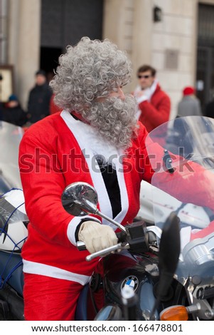 CRACOW, POLAND - DECEMBER 8, 2013: the parade of Santa Clauses on motorcycles around the Main Market Square in Cracow