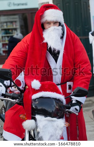 CRACOW, POLAND - DECEMBER 8, 2013: the parade of Santa Clauses on motorcycles around the Main Market Square in Cracow