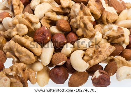 background of mixed nuts -  hazelnuts, walnuts, cashews,  pine nuts