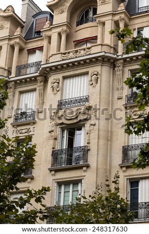 facade of typical house with balcony in Paris, France