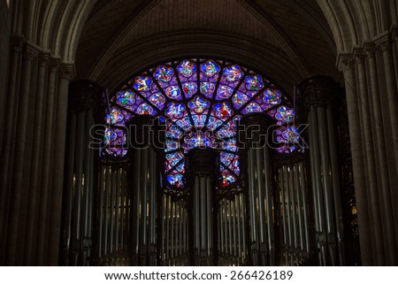 PARIS, FRANCE - SEPTEMBER 8, 2014: Organ and West rose window inside the Notre Dame Cathedral, The Vices and Virtues, the Signs of the Zodiac , the Labours of the Months.  Paris, France
