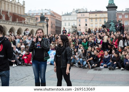 CRACOW, POLAND - MARCH 28, 2015:  the international Flashmob day of rueda de Casino,57 countries , 160 cities. Several hundred persons dance Hispanic rhythms on the Main Square in Cracow