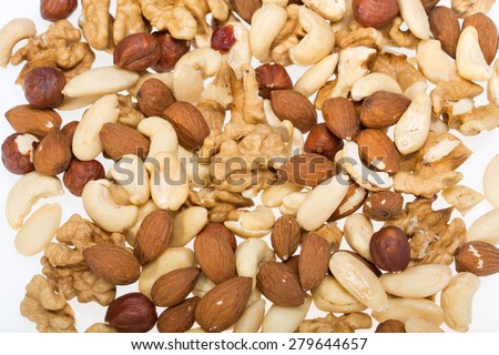background of mixed nuts -  hazelnuts, walnuts, cashews,  pine nuts