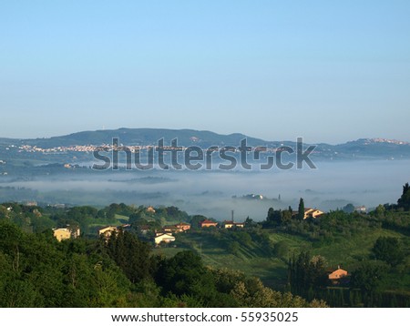 Fabulous landscape of the foggy morning in Tuscany. The valley between Montepulciano and Chiusi