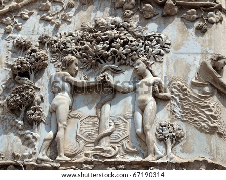 orvieto - Duomo facade. The first pillar: scenes from Genesis.Eve offers the forbidden fruit to Adam.