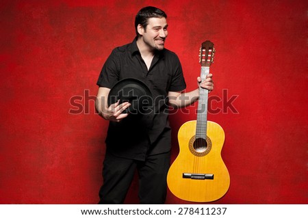 Young man thanking to the crowd after he played guitar