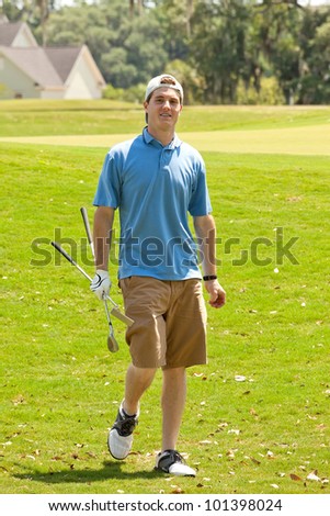 Young male golfer happy with the score of his golf game