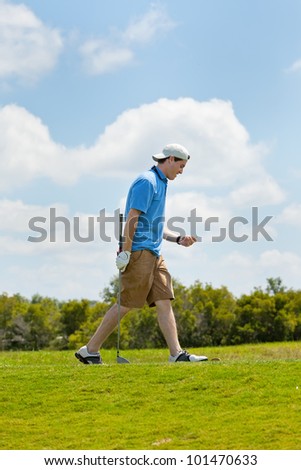 Young golfer content with his swing and placement of the ball down the fairway