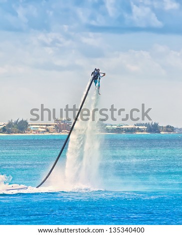 Man uses water jet pack on the Caribbean Sea