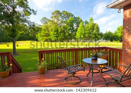 Residential Backyard Deck Overlooking Lawn And Lake