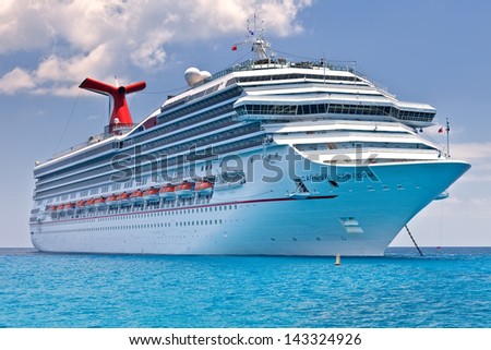 Grand Cayman, Cayman Islands - July 13: Carnival\'S Ship, Carnival Freedom, Anchored Off The Coast Of Grand Cayman On July 13, 2011. Passengers Have To Be Tendered To The Island For Day Excursions.