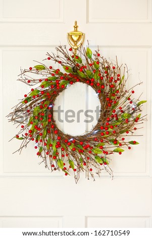 Decorative Christmas wreath on a white front door