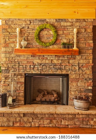 Large stone gas fireplace on interior deck