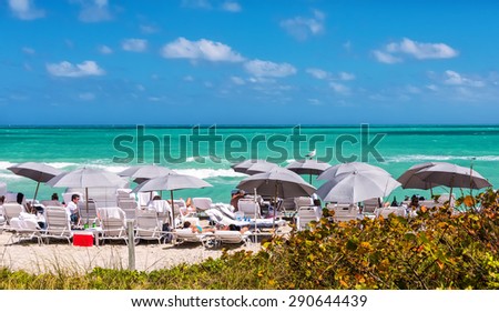 Miami, FL, USA - March 13, 2015:  Tourists enjoy South Beach on the tip of Miami in Florida.  South Beach is a major entertainment destination with hundreds of nightclubs, restaurants and hotels.