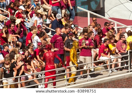 TALLAHASSEE, FL - OCT. 16:  The Garnet and Gold Guys, two unidentified FSU students who cover their bodies with glitter and paint, are the ultimate football fans and a crowd favorite on Oct. 16, 2010.