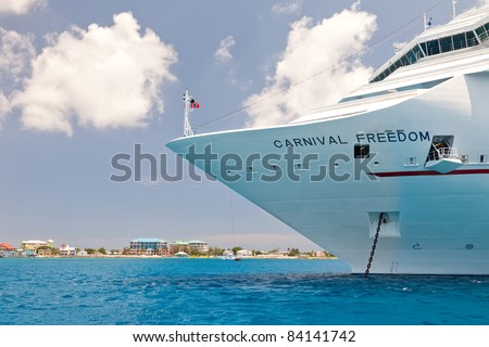 GRAND CAYMAN, CAYMAN ISLANDS  - JULY 13:  A cruise ship anchors near Grand Cayman and is required to tender visitors to the port on July 13, 2011.  Grand Cayman is the capital of the Cayman Islands.