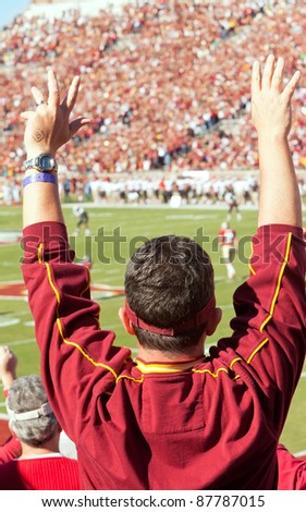 TALLAHASSEE, FL - OCT. 22:  Florida State football fan stands up and cheers at a home game as the FSU Seminoles play the Maryland Terps at Doak Campbell Stadium on Oct. 22, 2011.