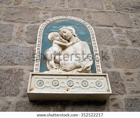 ABERDEEN, SCOTLAND - 11 DECEMBER 2015: A relief of Madonna and child soften the granite facade of the Cathedral House (parochial house) of St Mary\'s Roman Catholic Cathedral.