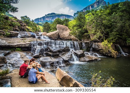 South Africa - January 19 2015: Boys enjoying the river waterfall in the park Drakensberg National Park