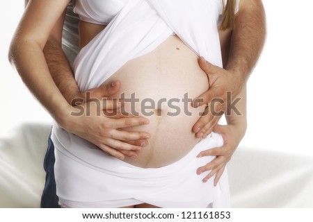 husband embraces a stomach to the pregnant wife