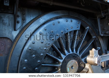 Close up of clean steam locomotive wheel showing con rod mechanism