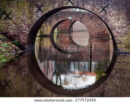 Reflections in the form of circles of three bridges in water of a canal in Den Bosch, The Netherlands