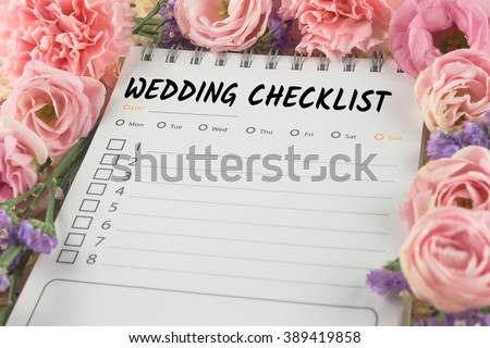 word wedding checklist note paper on pink flower background