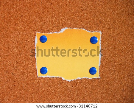 orange blank paper on cork board