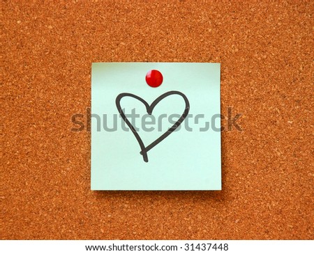 note pad on cork board with heart drawing