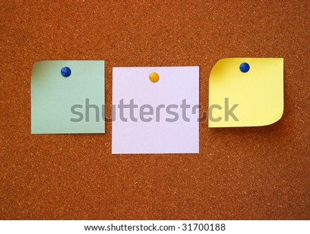 three note pads on cork board