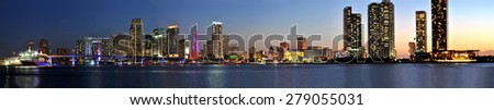 Miami, Florida, 5. April 2014 - Miami city skyline panorama at dusk with urban skyscrapers and bridge over sea.