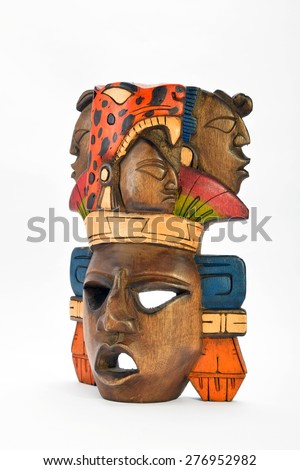 Indian Mayan Aztec wooden painted mask with roaring jaguar and human profiles isolated on white background (right side, ~ 45 degrees)