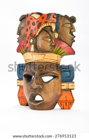 Indian Mayan Aztec wooden painted mask with roaring jaguar and human profiles isolated on white background (right side, ~ 30 degrees)