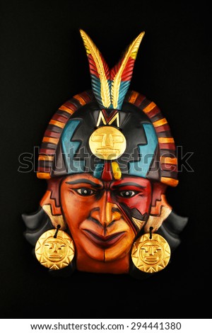 Indian Mayan Aztec ceramic mask with feather isolated on black paper background