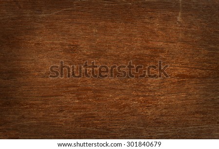 Old vintage brown wooden faded aged flat board with cracks, checks, other defects and shaded border