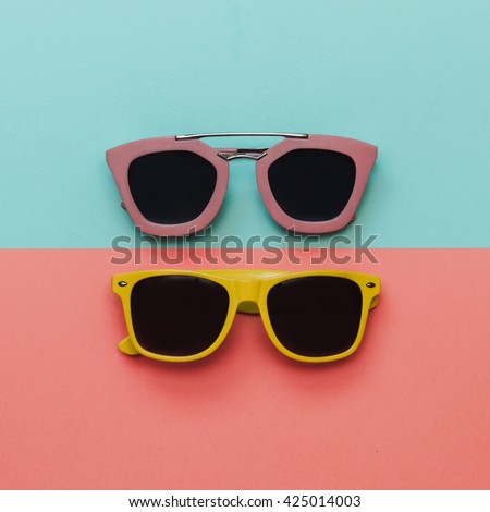 Flat lay fashion set:  two sunglasses on pastel backgrounds. Top view.