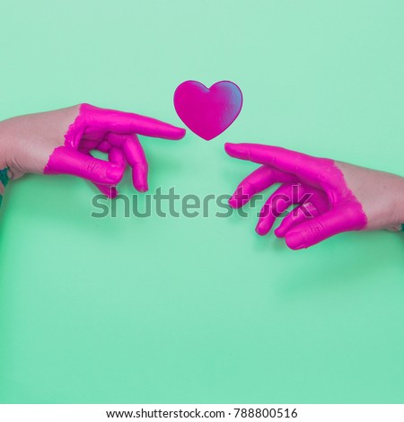 Two painted hands touch the heart by fingers.  Contemporary art collage.